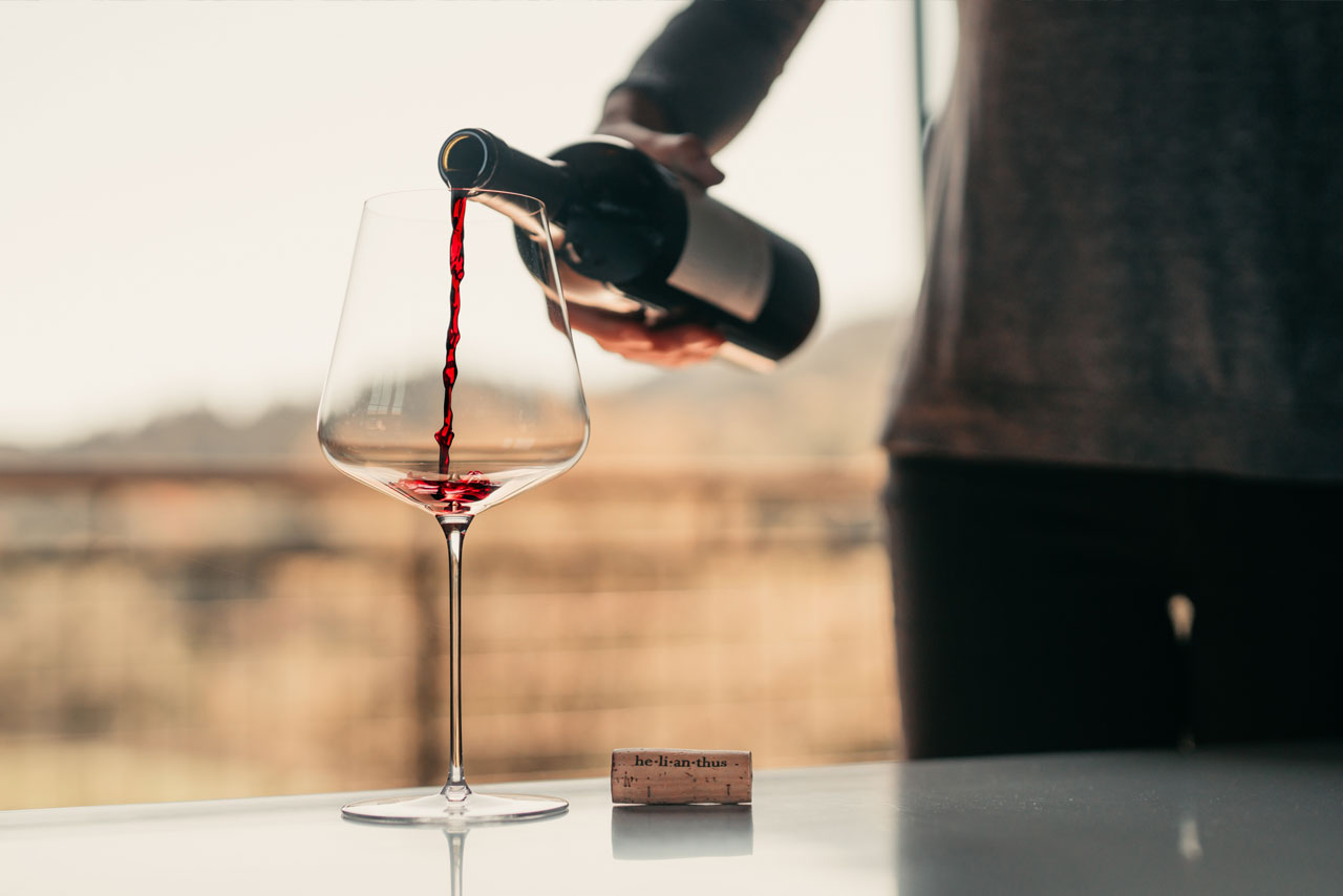 he-li-an-thus wine - Pouring red wine into a glass